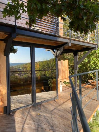 a view from the deck of a house with a balcony at Loft "Home, Sauna & Pool" in Osenbach