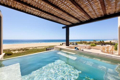 a swimming pool with a view of the beach at Kimpton Mas Olas Resort and Spa in Todos Santos