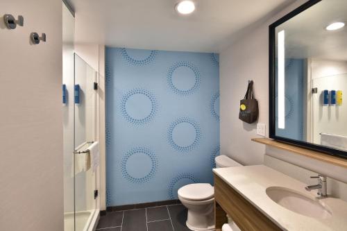 a bathroom with a toilet and a blue wall at Tru By Hilton Beckley, Wv in Beckley