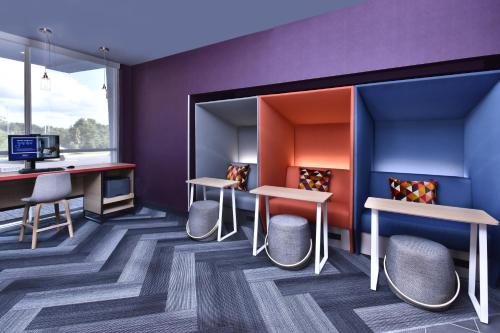 a room with tables and chairs and a desk at Tru By Hilton Beckley, Wv in Beckley