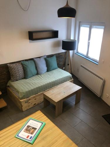 a living room with a couch and a coffee table at AlloAppartMeublé_L'écrin in Houilles