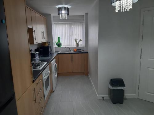 a kitchen with a sink and a stove top oven at 3 bedroom townhouse in Liverpool