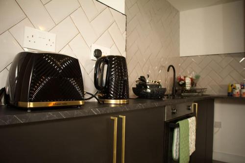 a kitchen counter with a toaster and a toaster oven at 1 Bed Apartment B in Birmingham