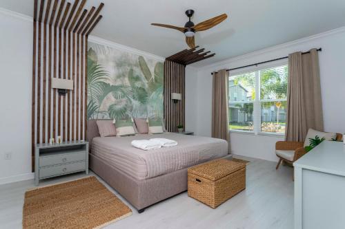 a bedroom with a bed and a ceiling fan at Wonderful 8Bd7BA Melbourne Beach w Pool Dock & Beach in Melbourne Beach