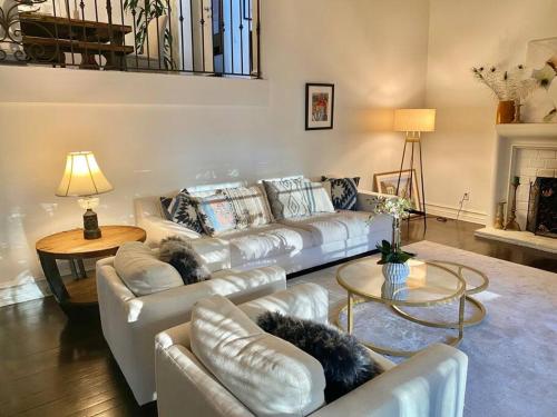 a living room with a white couch and a table at Entire villa on Sunset Strip in Los Angeles