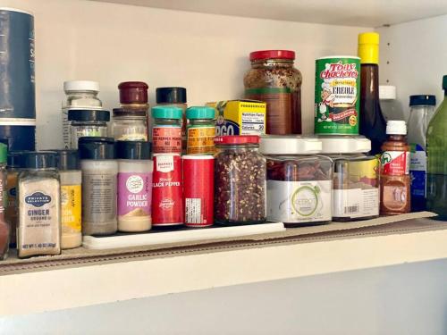a shelf filled with lots of jars of food at Entire villa on Sunset Strip in Los Angeles