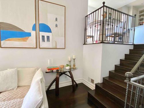 a living room with a table and a staircase at Entire villa on Sunset Strip in Los Angeles