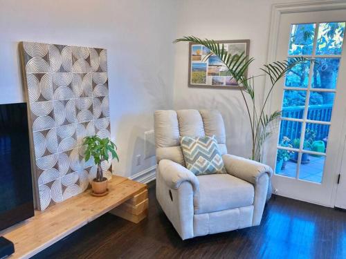 a living room with a chair and a table at Entire villa on Sunset Strip in Los Angeles