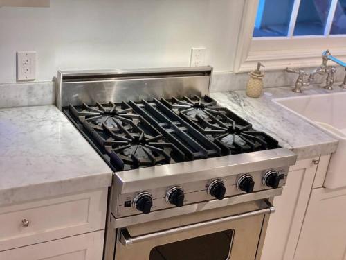 a stove top oven in a kitchen next to a sink at Entire villa on Sunset Strip in Los Angeles