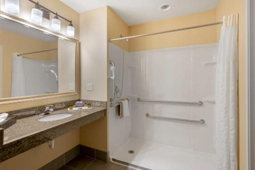 a bathroom with a shower and a sink at Best Western PLUS Fossil Country Inn & Suites in Kemmerer