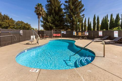 a swimming pool with blue water in a yard at Motel 6-Dixon, CA in Dixon