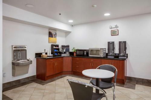 a kitchen with a table and some microwaves at Motel 6-Dixon, CA in Dixon