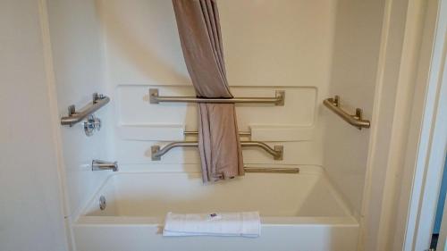 a bathroom with a bath tub and towel racks at Motel 6-Greensboro, NC - I-40 in Greensboro