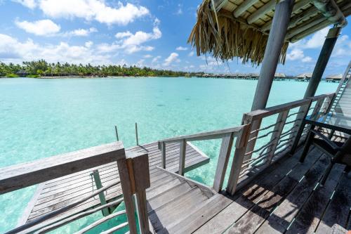 a wooden deck with a view of the water at InterContinental Bora Bora & Thalasso Spa by IHG in Bora Bora