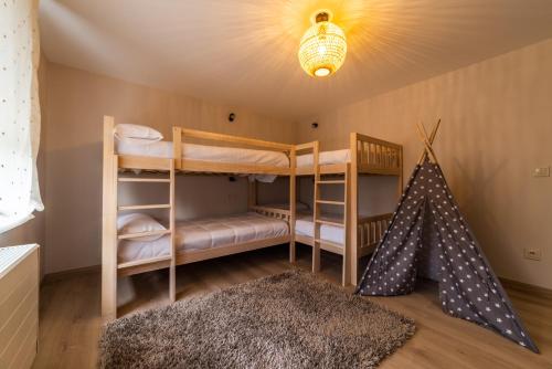 a room with two bunk beds and a rug at Villa Rucheira -Costa da Morte- in A Coruña