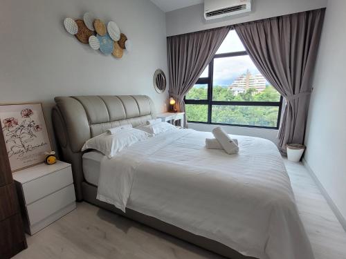 a bedroom with a large bed and a large window at Bee Homestay - Jesselton Quay Kota Kinabalu in Kota Kinabalu