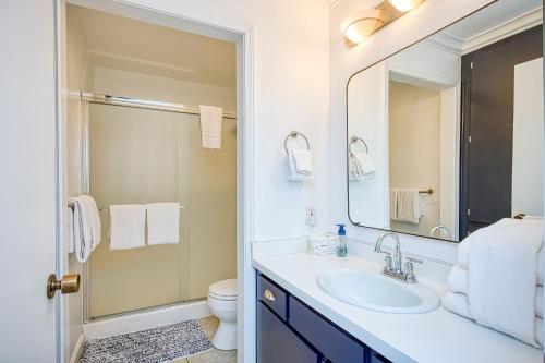 a bathroom with a sink and a toilet and a mirror at Huntington Lake Condo 115 in Lakeshore
