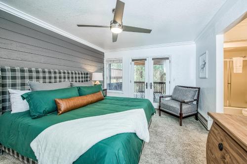 a bedroom with a large green bed and a chair at Huntington Lake Condo 115 in Lakeshore