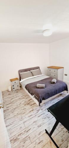 a bedroom with a large bed and a wooden floor at City centre lovely Apartment with the Cheapest Overnight Parking in Leicester