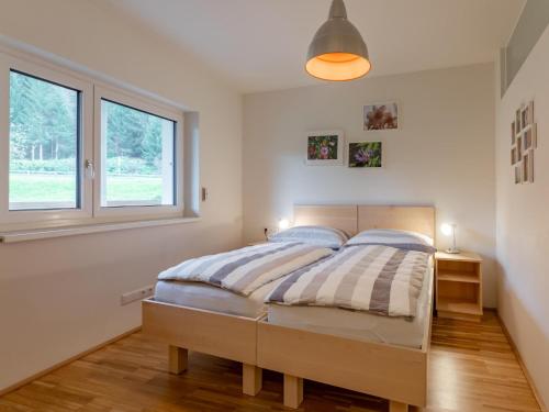 a bedroom with a bed and a window at Lungau Residence Top 0-6 in Tamsweg