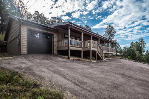 a house with a large driveway in front of it at Moon Mountain Escape in Ruidoso