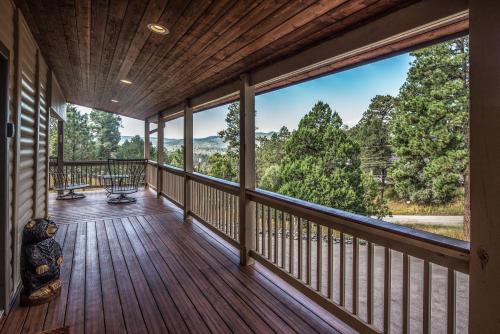 a large deck with a view of the mountains at Moon Mountain Escape in Ruidoso