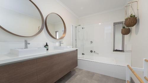 a bathroom with a sink and a mirror at South Coast Retreat in Inverloch