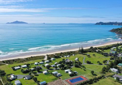 an aerial view of a campground next to the beach at Camp Waipu Cove in Waipu
