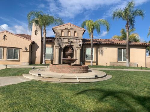 a house with a fountain in the middle of a yard at AirBB Rooms in Mansion in Riverside