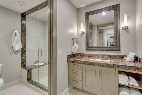 a bathroom with a sink and a shower and a mirror at Premium Two Bedroom apartment hotel in Park City