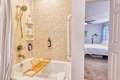 a bathroom with a tub and a bedroom at Blissful Beach Retreat with Screened-in Pool in Ocean Springs