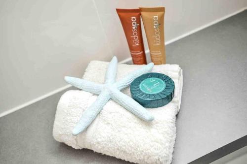 a towel with a starfish and a tube of toothpaste at Sea Breeze 3BR WIFI Family and Pet friendly in Middleton