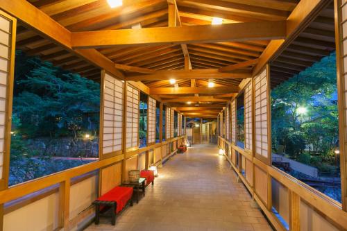 a hallway in a building with a mural on the walls at Arima Onsen Gekkoen Yugetsusanso in Kobe
