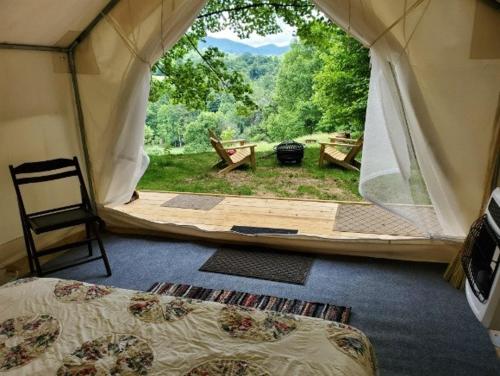 a room with a tent with a view of a yard at Tentrr Signature Site - Greener Acres Roan Mountain View in Roan Mountain