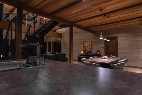 a kitchen and dining room with a large counter top at Hygge Chalet Hakuba in Hakuba