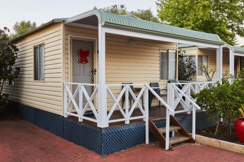 a cabin with a porch and a deck at BIG4 Breeze Holiday Parks - Busselton in Busselton