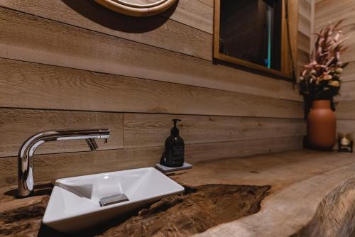 a bathroom with a sink and a bottle of wine at Hygge Chalet Hakuba in Hakuba