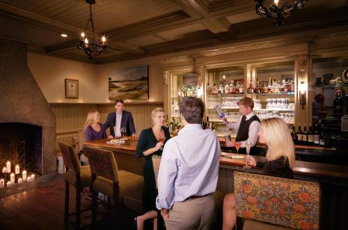 a group of people standing around a bar at Wentworth Mansion in Charleston