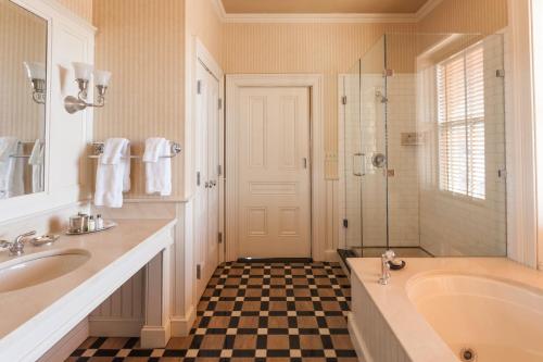 a bathroom with a tub and a shower and a sink at Wentworth Mansion in Charleston