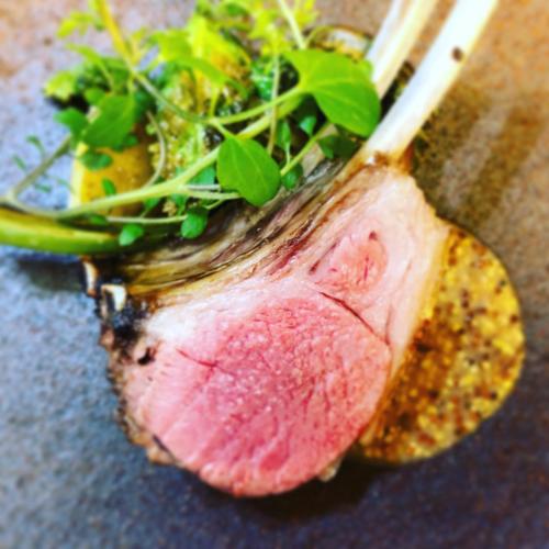 a close up of a piece of meat with greens on it at 洲本家　SUMOTOYA in Sumoto