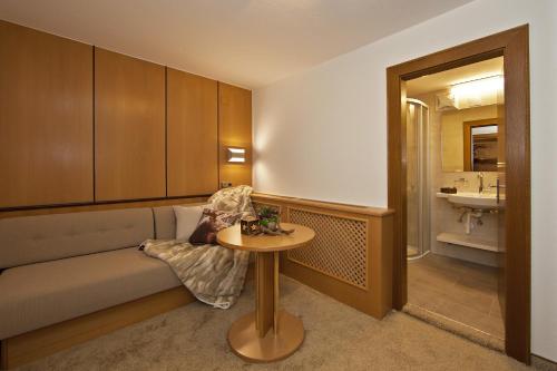 a living room with a couch and a table at Villa Michaela in Gerlos