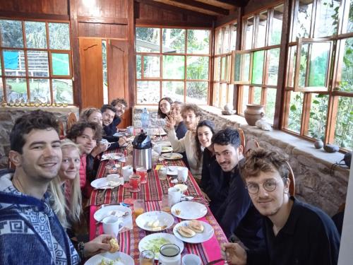 a group of people sitting at a table in a restaurant at Lia B&B Lucmabamba in Sahuayacu