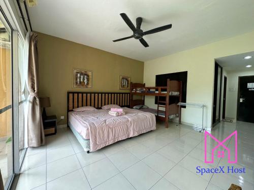 a bedroom with a bed and a ceiling fan at Gold Coast Morib Resort in Banting