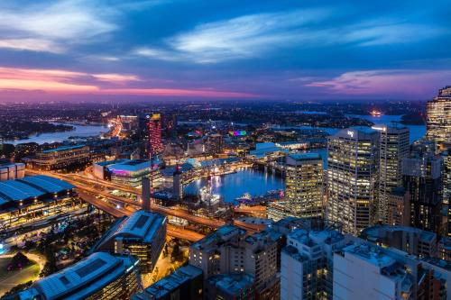 a view of a city at night at Meriton Suites Kent Street, Sydney in Sydney