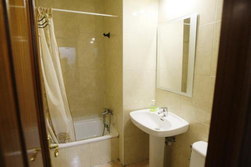 a bathroom with a sink and a shower at Hostal San Fernando in Alicante