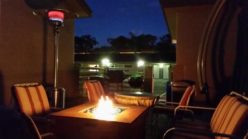 a table with a fire on top of it with chairs at Lone Oak Lodge in Monterey