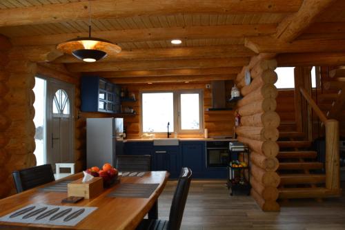 eine Küche mit einem Holztisch in einer Hütte in der Unterkunft Magura little chalet in Măgura