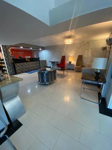 a living room with a couch and a table at Baymont Inn by Wyndham Odessa University Area in Odessa