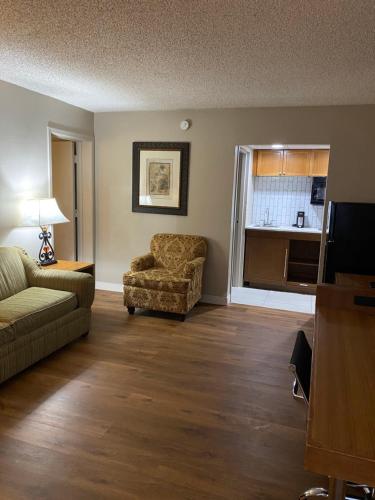 a living room with a couch and a chair at Baymont Inn by Wyndham Odessa University Area in Odessa