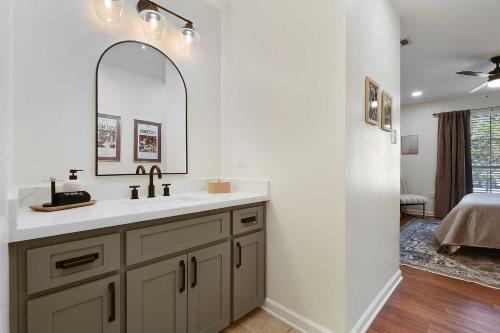 a bathroom with a sink and a mirror at Charming Baton Rouge Retreat about 3 Mi to LSU! in Baton Rouge